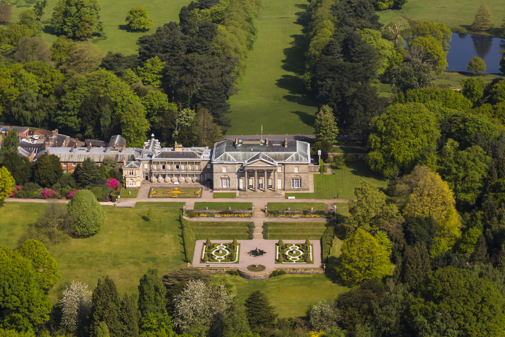 Tatton Park mansion and its formal gardens seen from above, surrounded by parkland