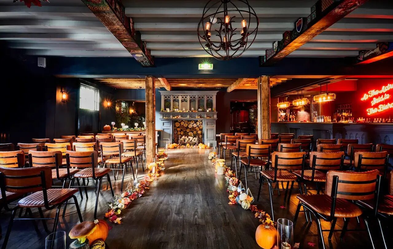 An autumn ceremony aisle in the Main Bar, lined with pumpkins, candles and leaves